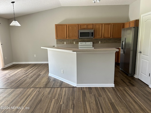 kitchen with brown cabinetry, lofted ceiling, stainless steel appliances, dark wood-type flooring, and light countertops