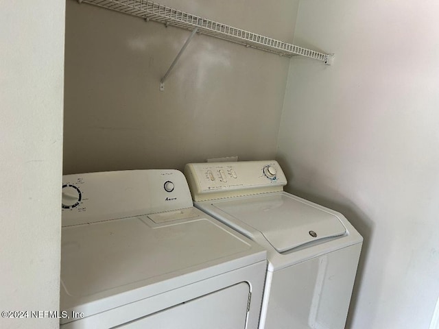 washroom with washing machine and clothes dryer and laundry area