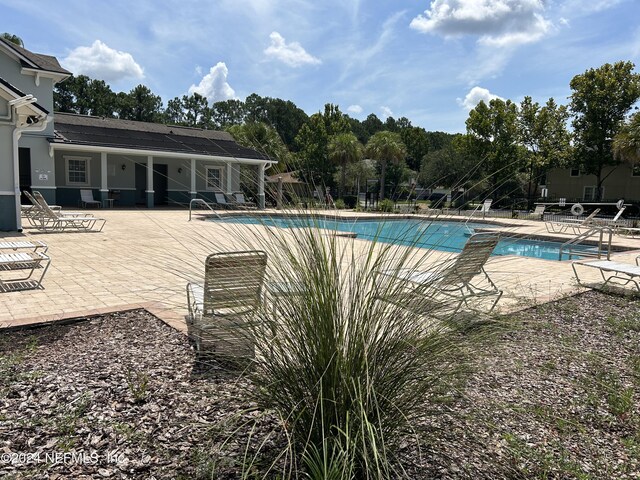 view of swimming pool featuring a patio area