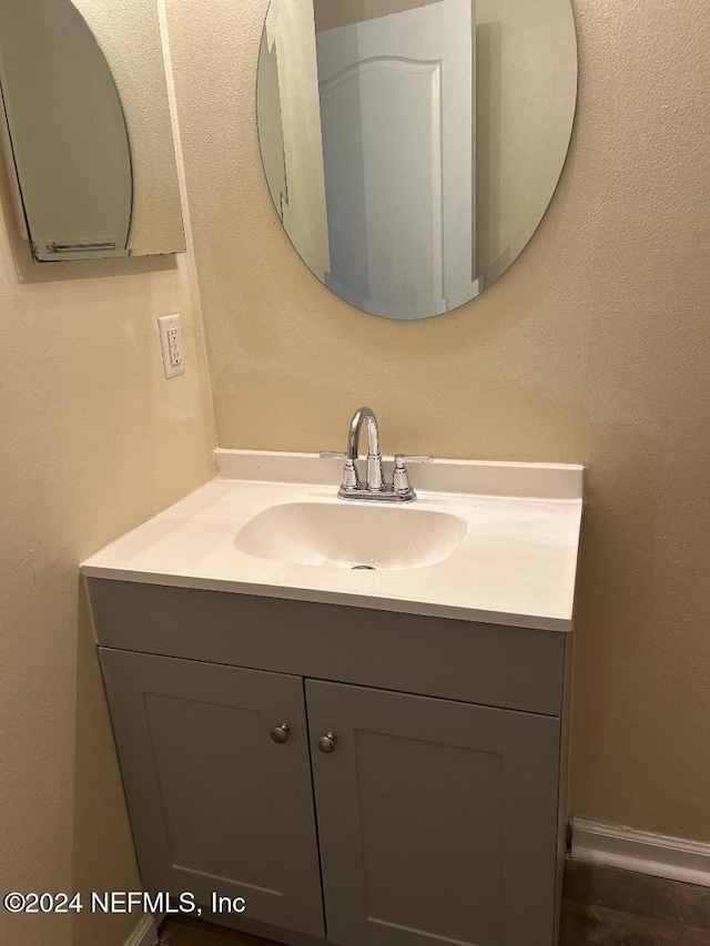 bathroom with vanity and baseboards