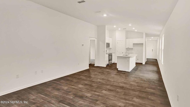 unfurnished living room with dark hardwood / wood-style flooring, vaulted ceiling, and sink