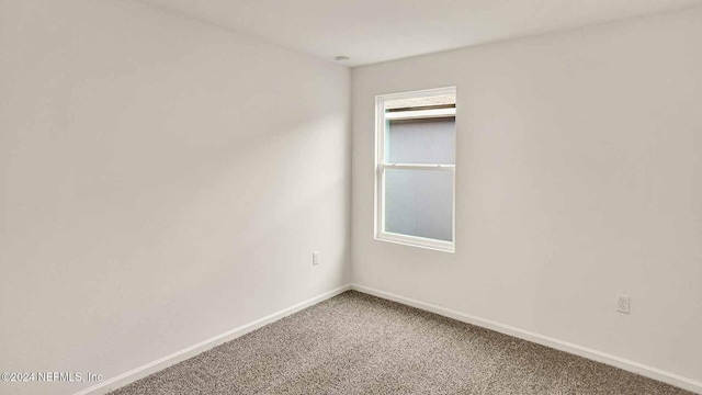 carpeted spare room with plenty of natural light