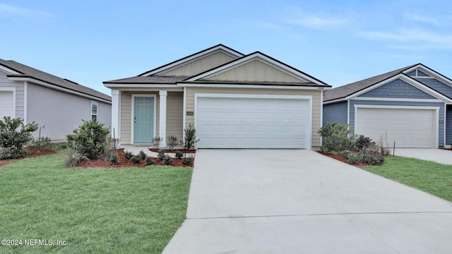 view of front of property featuring a garage and a front yard