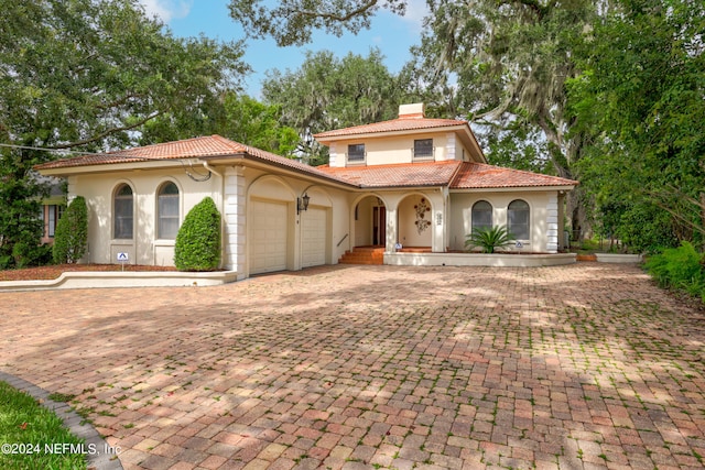 mediterranean / spanish-style home featuring a garage