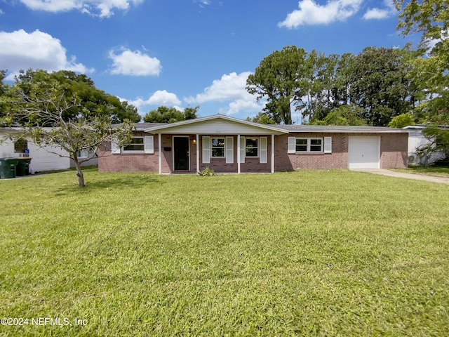 ranch-style home featuring covered porch, a front yard, and a garage