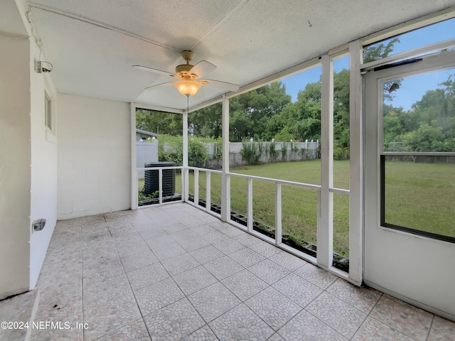 unfurnished sunroom with ceiling fan and a healthy amount of sunlight