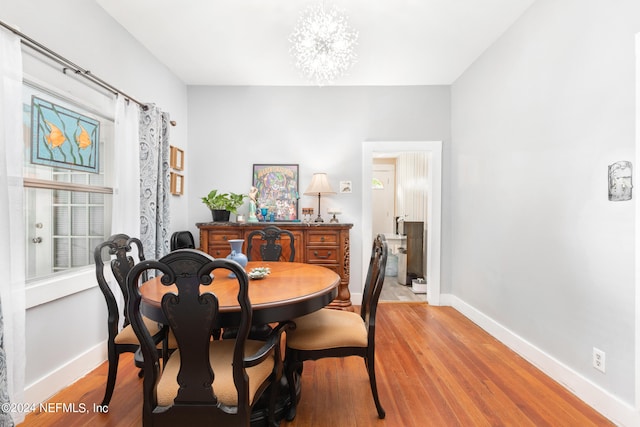 dining room with a notable chandelier and light hardwood / wood-style floors