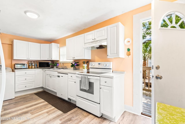 kitchen with white appliances, white cabinetry, and washer / dryer