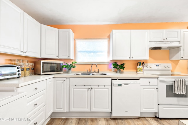 kitchen featuring white cabinets, sink, and white appliances