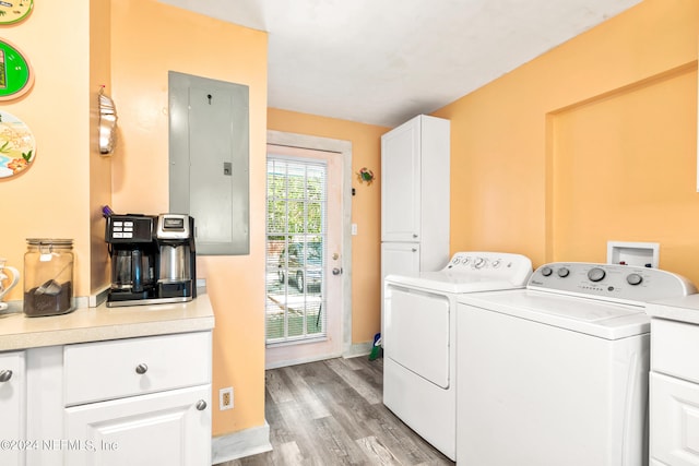 laundry room featuring light wood-type flooring, electric panel, and independent washer and dryer