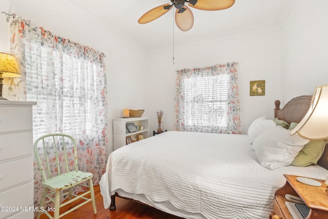 bedroom featuring ceiling fan, hardwood / wood-style floors, and crown molding