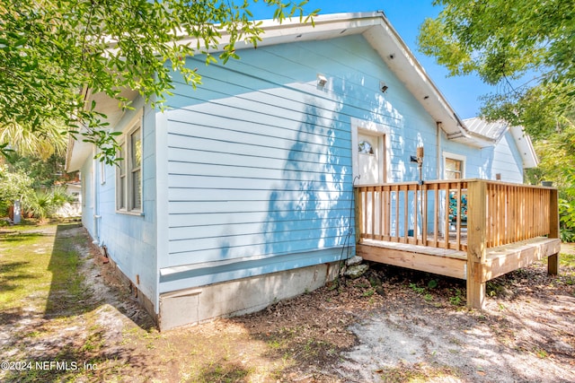 rear view of house featuring a deck