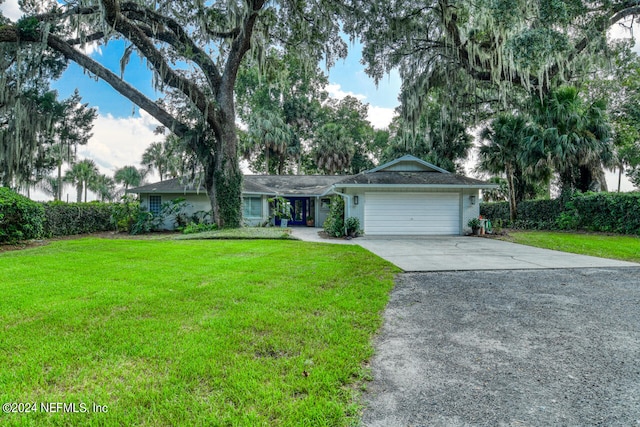 single story home featuring a garage and a front yard