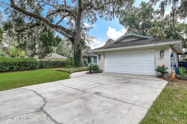 view of side of property featuring a garage and a yard