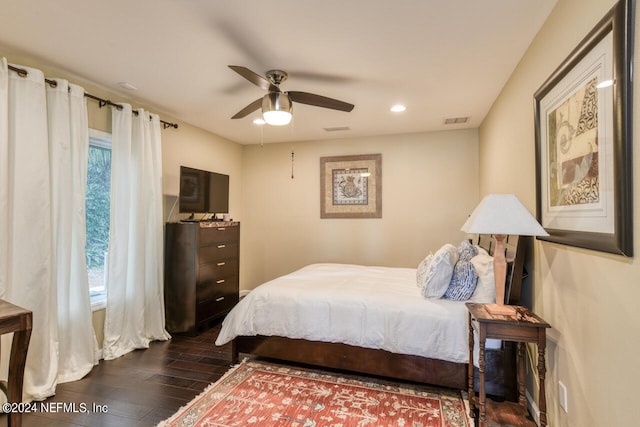 bedroom with ceiling fan and dark wood-type flooring