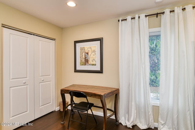 office with a healthy amount of sunlight and dark hardwood / wood-style flooring