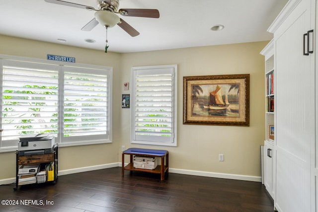 sitting room with a wealth of natural light, dark hardwood / wood-style floors, and ceiling fan