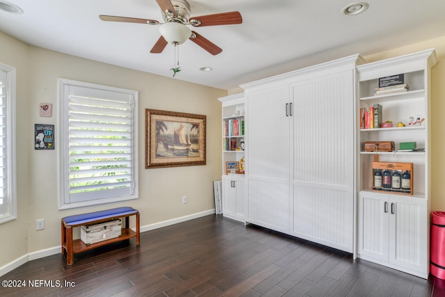 interior space with ceiling fan and dark hardwood / wood-style flooring