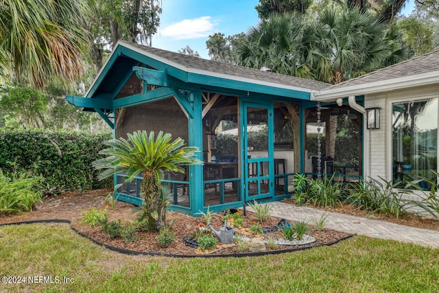 view of outbuilding with a sunroom