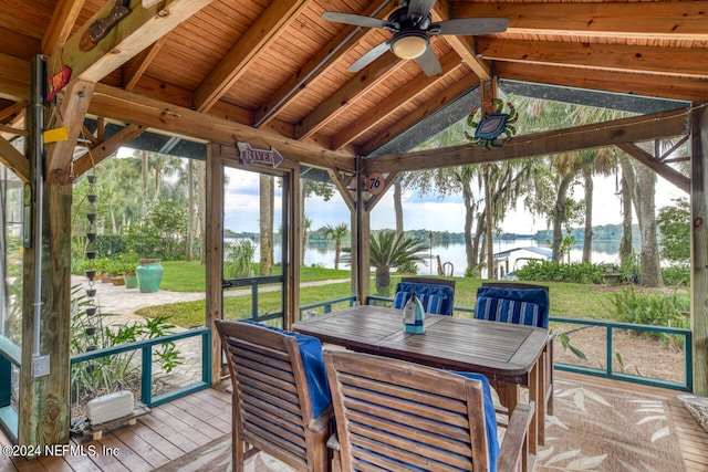 sunroom / solarium with wooden ceiling, vaulted ceiling with beams, ceiling fan, and a water view