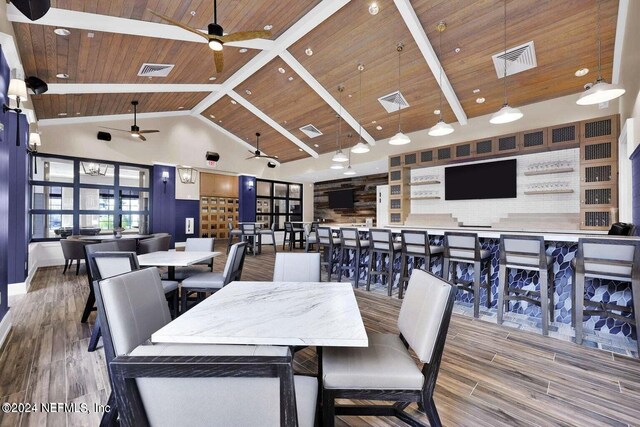 dining room with ceiling fan, beamed ceiling, wood ceiling, high vaulted ceiling, and hardwood / wood-style flooring