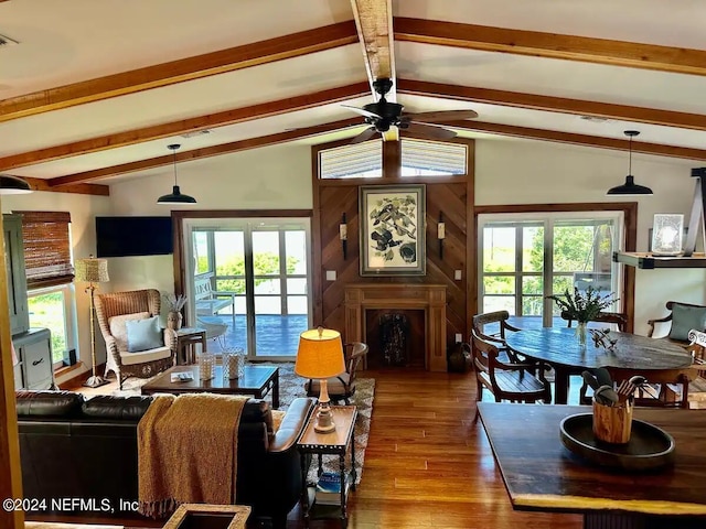 living room featuring lofted ceiling with beams, ceiling fan, hardwood / wood-style flooring, and french doors