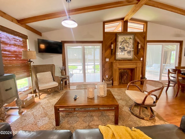 living room with hardwood / wood-style flooring, a healthy amount of sunlight, and lofted ceiling with beams