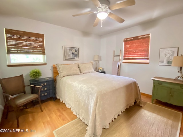 bedroom featuring light hardwood / wood-style floors and ceiling fan