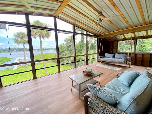 sunroom / solarium featuring ceiling fan, lofted ceiling, and a water view