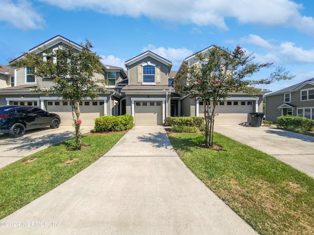 view of front of house with driveway, an attached garage, a residential view, and stucco siding