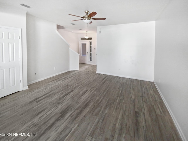 unfurnished living room featuring ceiling fan, wood finished floors, visible vents, and baseboards