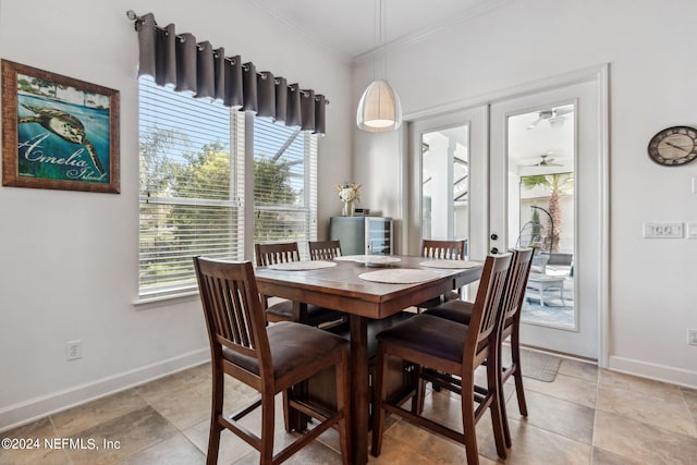 dining room featuring baseboards, ceiling fan, french doors, and crown molding