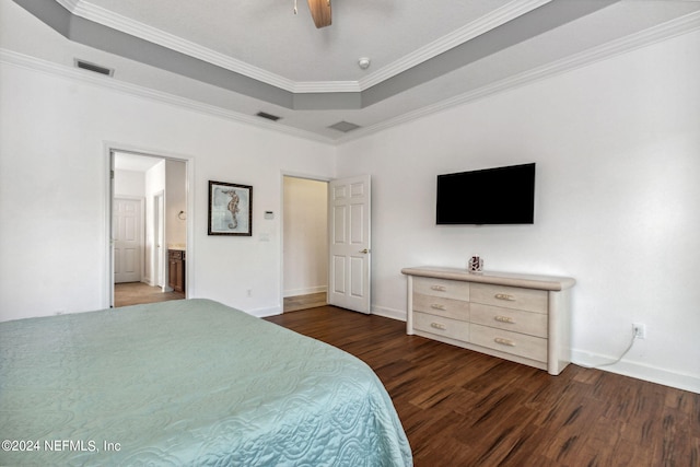 bedroom featuring dark wood-style floors, visible vents, a raised ceiling, and crown molding