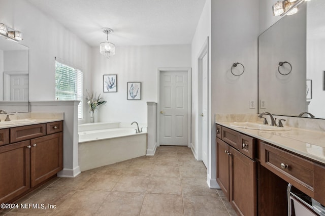 full bathroom with tile patterned flooring, two vanities, a sink, and a bath