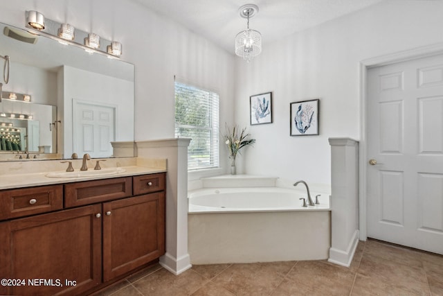 bathroom featuring tile patterned flooring, vanity, baseboards, and a bath