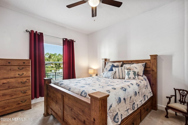 bedroom featuring light carpet and a ceiling fan