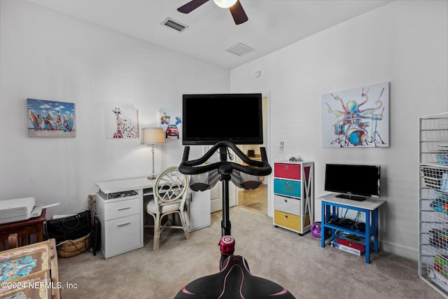 office with ceiling fan, visible vents, vaulted ceiling, and light colored carpet