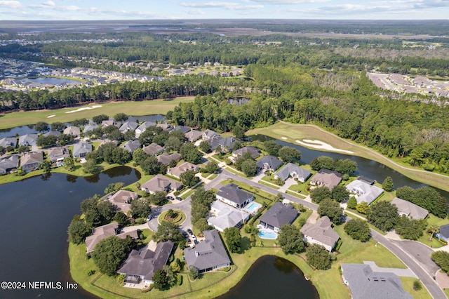 drone / aerial view with a water view and a residential view