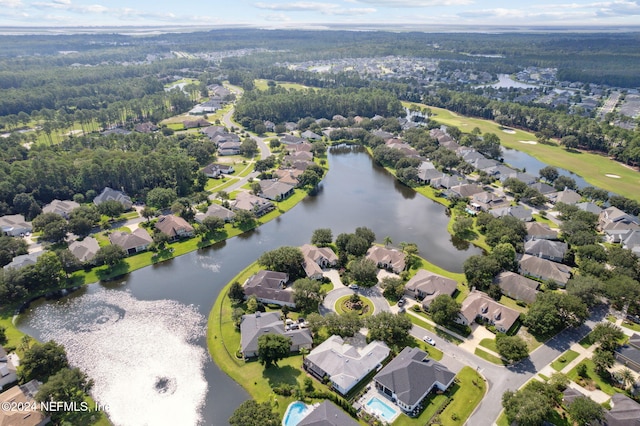 drone / aerial view with a water view and a residential view