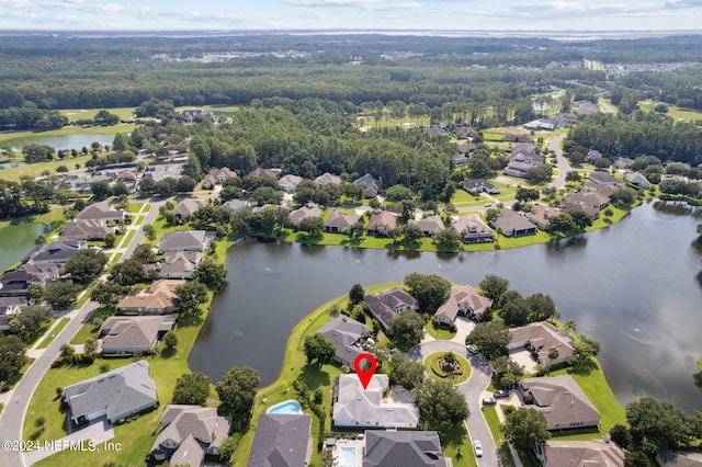 drone / aerial view featuring a water view and a residential view