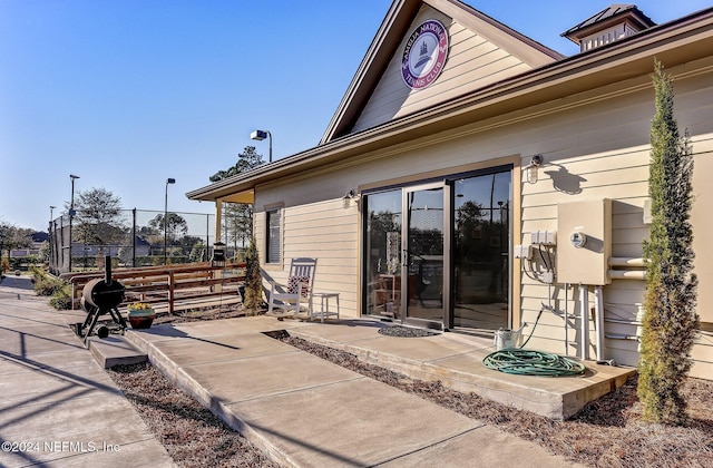 doorway to property with a patio area and fence