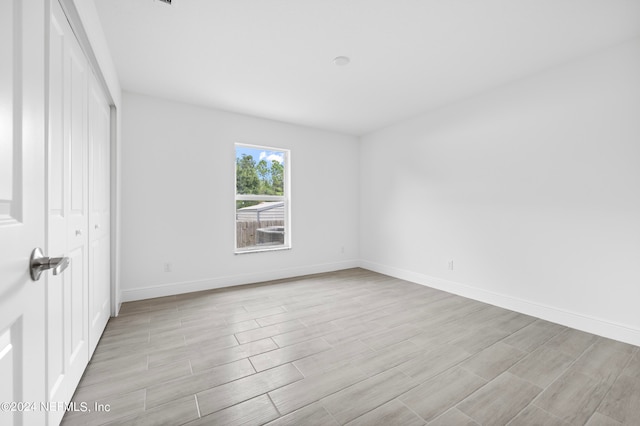 empty room with light hardwood / wood-style flooring