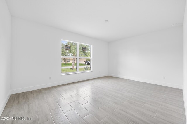 spare room featuring light hardwood / wood-style flooring