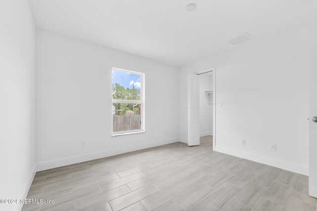 empty room with light hardwood / wood-style floors