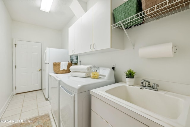 133 Sawmill Lakes Blvd, Ponte Vedra Beach, FL 32082 - laundry room with cabinet space, washing machine and clothes dryer, light tile patterned flooring, and baseboards