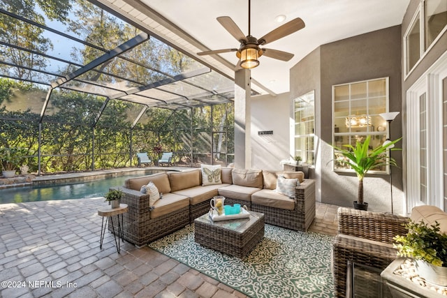 view of patio featuring outdoor lounge area, ceiling fan, and a lanai