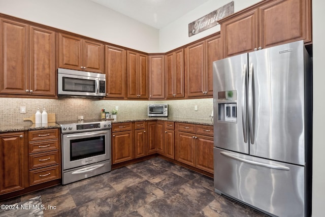 133 Sawmill Lakes Blvd, Ponte Vedra Beach, FL 32082 - kitchen featuring appliances with stainless steel finishes, brown cabinetry, decorative backsplash, stone countertops, and dark stone finish flooring