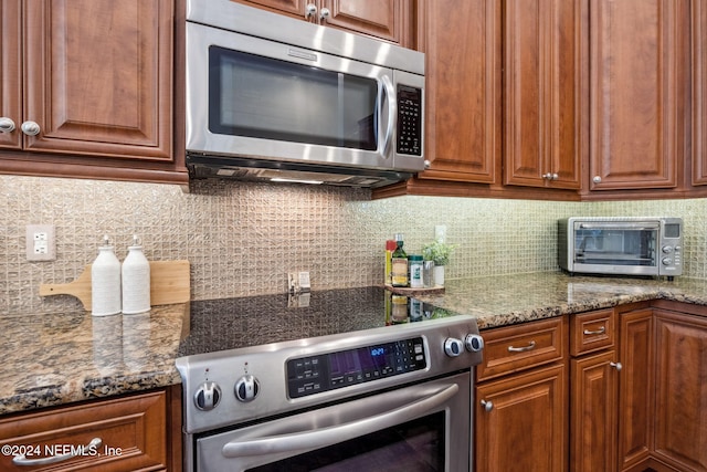 133 Sawmill Lakes Blvd, Ponte Vedra Beach, FL 32082 - kitchen featuring appliances with stainless steel finishes, decorative backsplash, brown cabinetry, and stone countertops