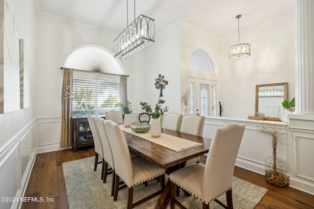 133 Sawmill Lakes Blvd, Ponte Vedra Beach, FL 32082 - dining area with a chandelier, wood finished floors, ornamental molding, a wainscoted wall, and a towering ceiling