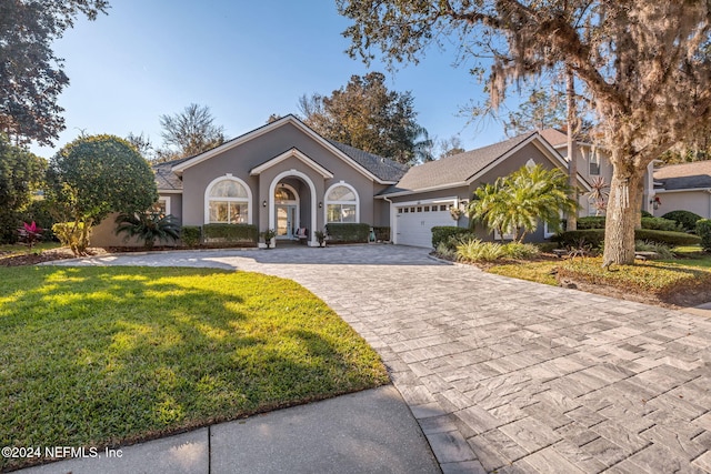 single story home with a front yard and a garage